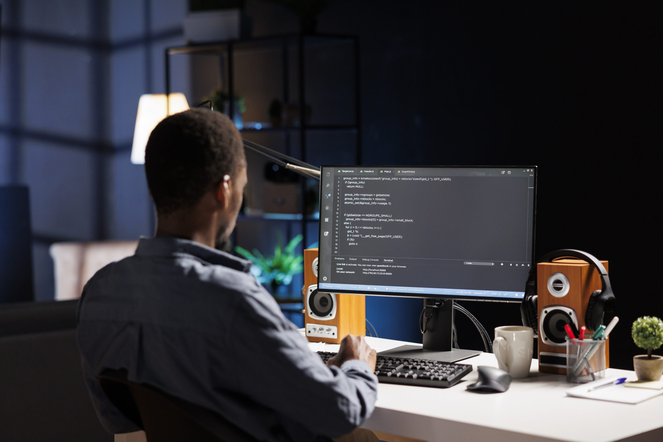 A developer coding on a desktop computer