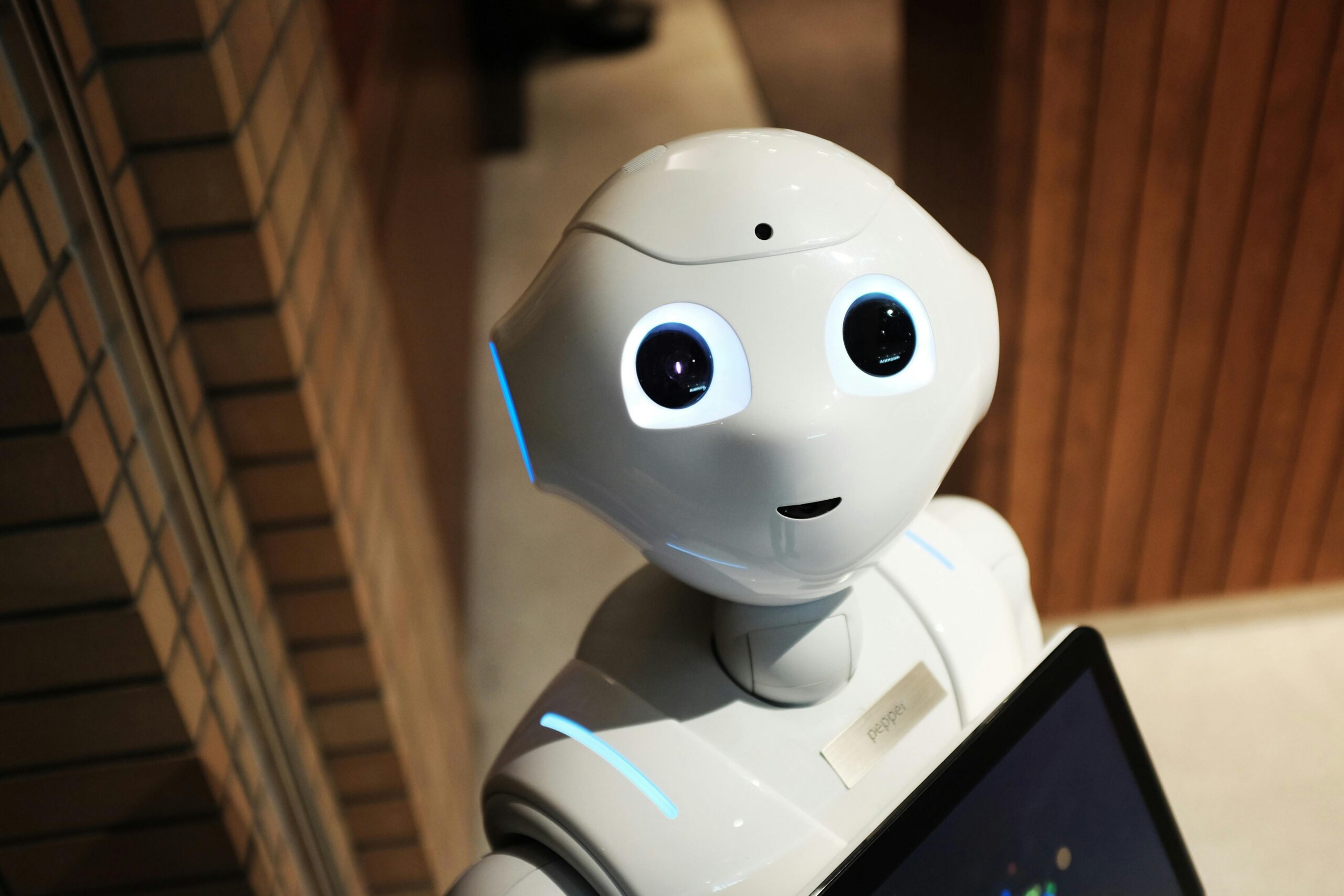 A humanoid robot with glowing eyes and a screen interface