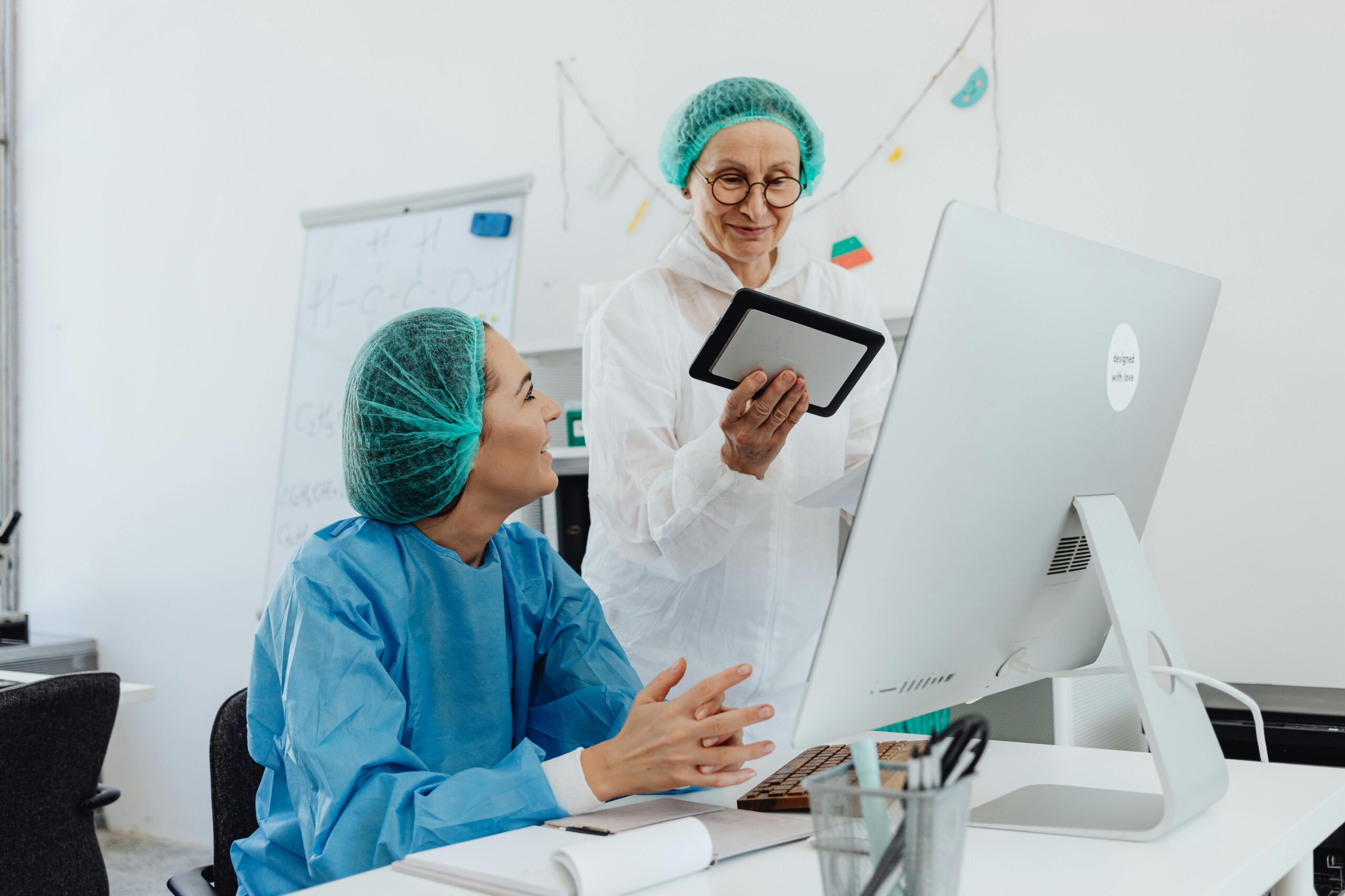 two medical professionals talking in an office